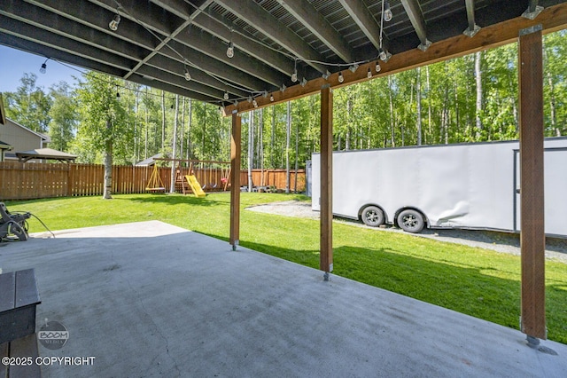 13378 Rosser Dr, Eagle River, AK 99577 - fenced backyard featuring a playground and a patio area