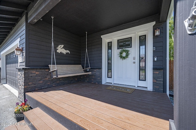 13378 Rosser Dr, Eagle River, AK 99577 - doorway to property with stone siding and covered porch