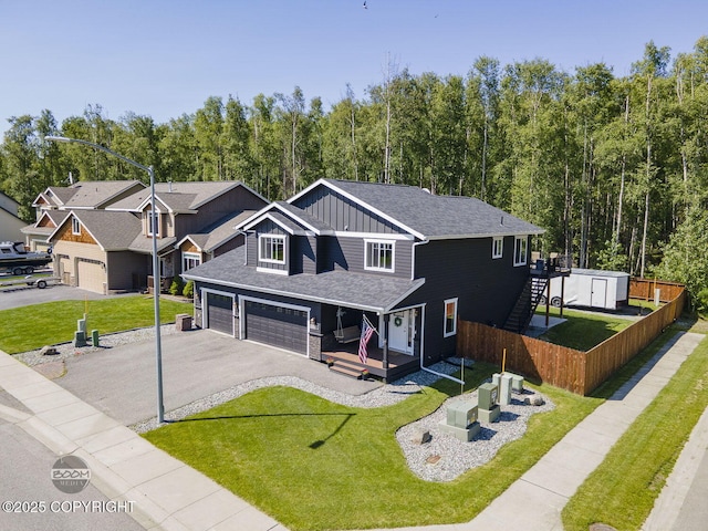 13378 Rosser Dr, Eagle River, AK 99577 - view of front facade with board and batten siding, asphalt driveway, an attached garage, and roof with shingles