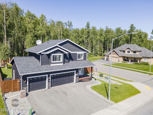 13378 Rosser Dr, Eagle River, AK 99577 - view of front of property with driveway, board and batten siding, stone siding, covered porch, and a shingled roof