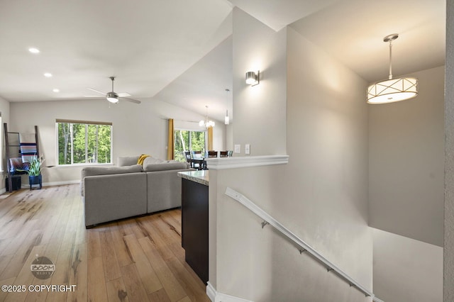 13378 Rosser Dr, Eagle River, AK 99577 - living room with light wood finished floors, lofted ceiling, ceiling fan, recessed lighting, and a chandelier