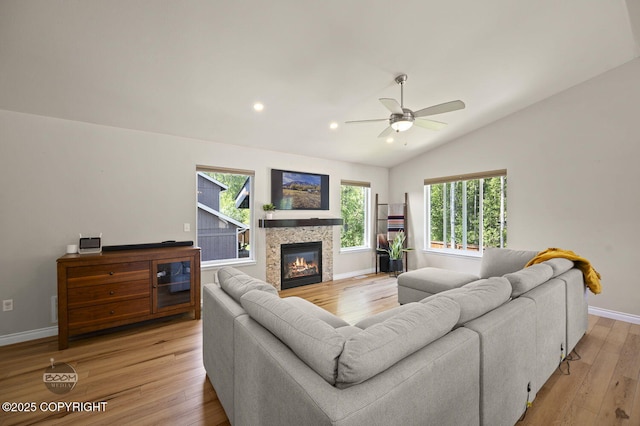 13378 Rosser Dr, Eagle River, AK 99577 - living room with light wood finished floors, lofted ceiling, ceiling fan, a tiled fireplace, and recessed lighting