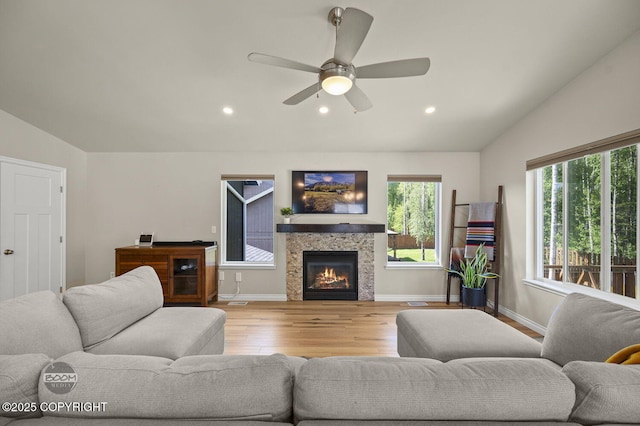 13378 Rosser Dr, Eagle River, AK 99577 - living room with wood finished floors, recessed lighting, vaulted ceiling, a glass covered fireplace, and a ceiling fan