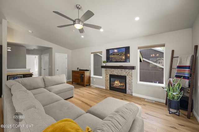13378 Rosser Dr, Eagle River, AK 99577 - living room featuring vaulted ceiling, wood finished floors, ceiling fan, a glass covered fireplace, and recessed lighting