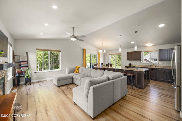 13378 Rosser Dr, Eagle River, AK 99577 - living area featuring light wood-style flooring, vaulted ceiling, ceiling fan, recessed lighting, and a fireplace