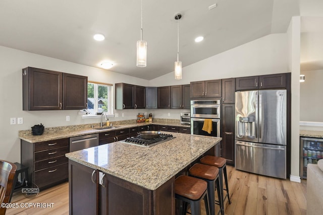 13378 Rosser Dr, Eagle River, AK 99577 - kitchen featuring stainless steel appliances, dark brown cabinets, light wood finished floors, vaulted ceiling, and light stone countertops