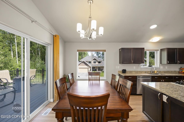 13378 Rosser Dr, Eagle River, AK 99577 - dining area featuring light wood-type flooring and a chandelier