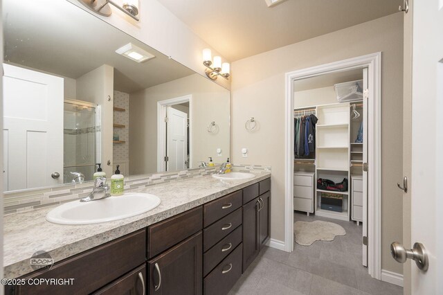 13378 Rosser Dr, Eagle River, AK 99577 - full bathroom featuring double vanity, a walk in closet, a shower stall, and tile patterned flooring