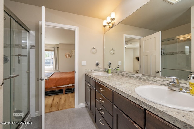 13378 Rosser Dr, Eagle River, AK 99577 - ensuite bathroom with double vanity, a shower stall, ceiling fan, and tile patterned flooring