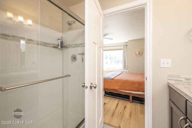 13378 Rosser Dr, Eagle River, AK 99577 - ensuite bathroom featuring wood finished floors, vanity, and a stall shower