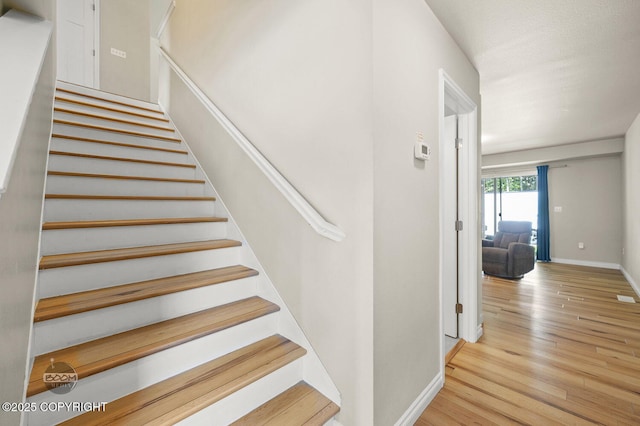 13378 Rosser Dr, Eagle River, AK 99577 - stairway featuring wood finished floors and baseboards