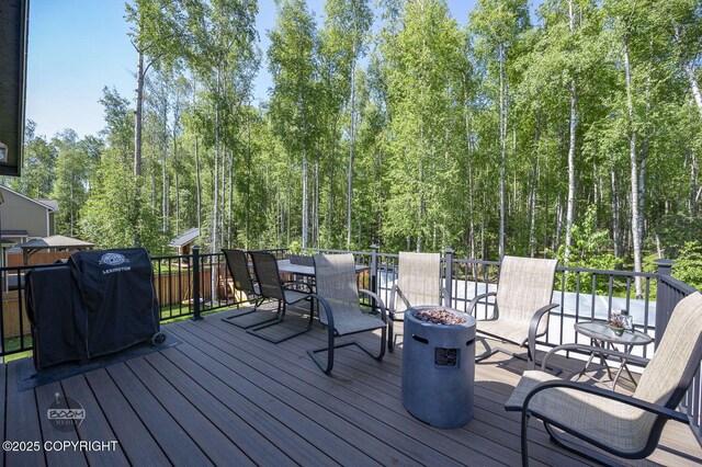 13378 Rosser Dr, Eagle River, AK 99577 - wooden terrace with an outdoor fire pit, a grill, and outdoor dining space