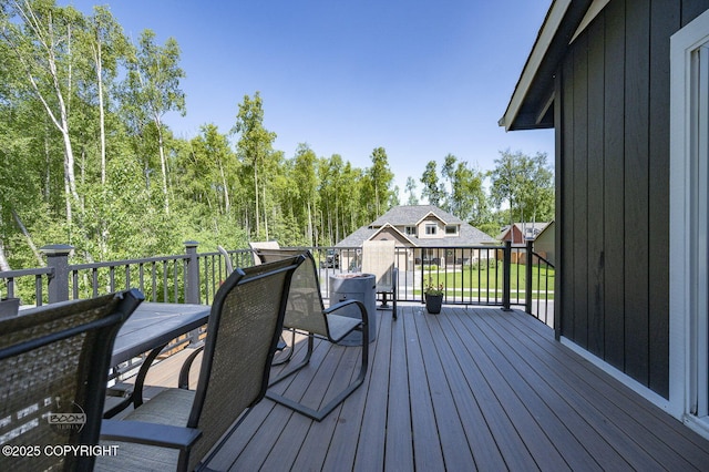 13378 Rosser Dr, Eagle River, AK 99577 - wooden terrace with outdoor dining area and an outdoor structure