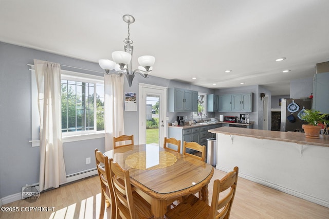 8100 E 20th Ave, Anchorage, AK 99504 - dining space featuring a chandelier, light wood-type flooring, healthy amount of natural light, and recessed lighting