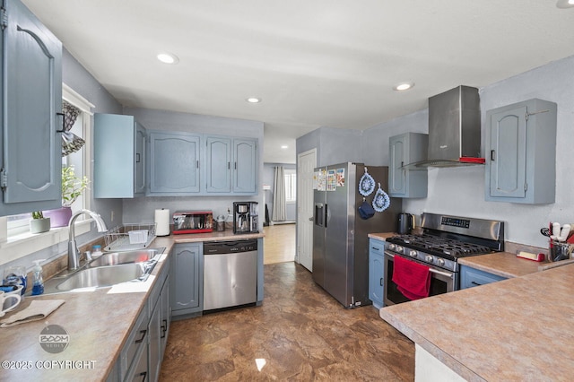 8100 E 20th Ave, Anchorage, AK 99504 - kitchen with stainless steel appliances, wall chimney range hood, light countertops, recessed lighting, and gray cabinetry