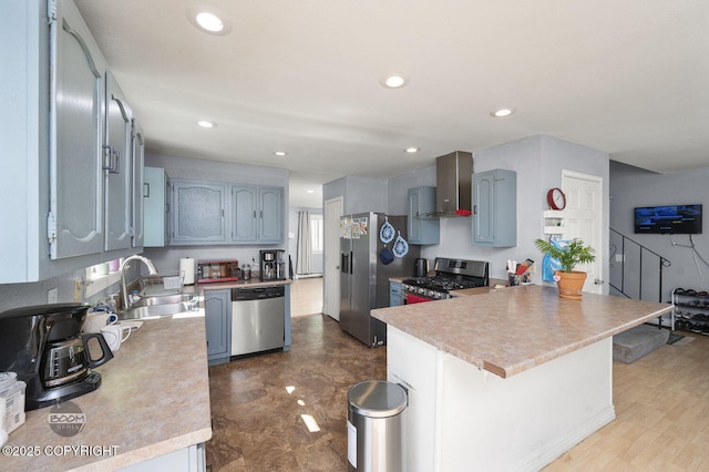 8100 E 20th Ave, Anchorage, AK 99504 - kitchen featuring stainless steel appliances, a peninsula, wall chimney exhaust hood, light countertops, and recessed lighting