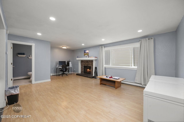 8100 E 20th Ave, Anchorage, AK 99504 - living room featuring a baseboard radiator, recessed lighting, light wood-style flooring, and a fireplace