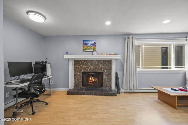 8100 E 20th Ave, Anchorage, AK 99504 - office area with wood finished floors, a tile fireplace, and recessed lighting