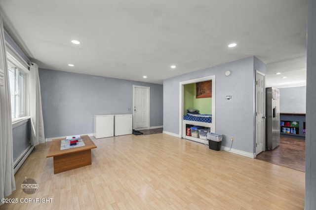 8100 E 20th Ave, Anchorage, AK 99504 - living room with baseboard heating, recessed lighting, and wood finished floors