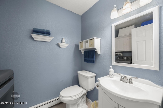 8100 E 20th Ave, Anchorage, AK 99504 - half bath featuring vanity, baseboard heating, and washer / dryer