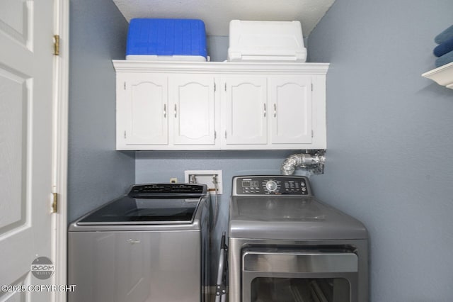 8100 E 20th Ave, Anchorage, AK 99504 - laundry area featuring independent washer and dryer and cabinet space