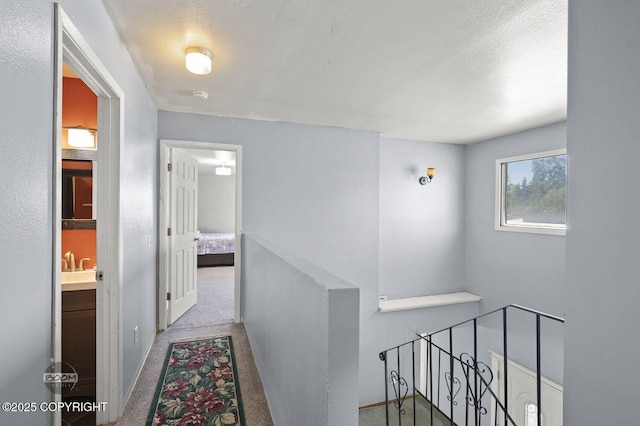 8100 E 20th Ave, Anchorage, AK 99504 - corridor featuring an upstairs landing and carpet floors