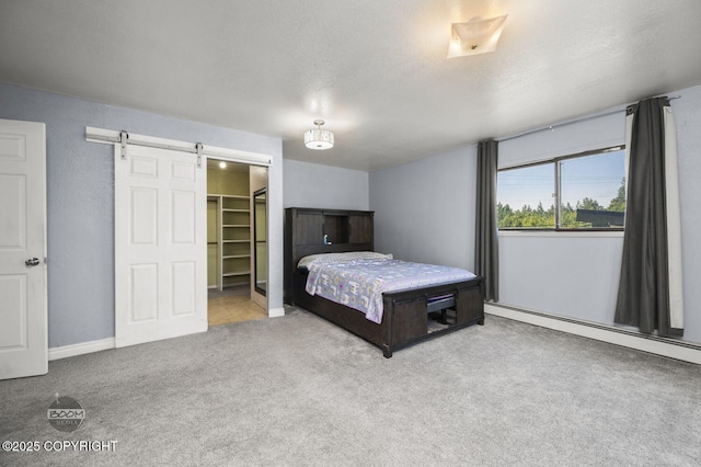 8100 E 20th Ave, Anchorage, AK 99504 - bedroom featuring a barn door, carpet, and a spacious closet