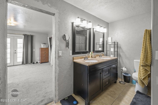 8100 E 20th Ave, Anchorage, AK 99504 - full bath featuring a textured wall, a textured ceiling, double vanity, tile patterned floors, and a shower