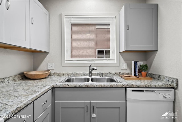 943 E 12th Ave # 6, Anchorage, AK 99501 - kitchen with white dishwasher, a sink, gray cabinetry, and light countertops