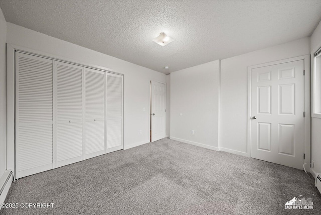 943 E 12th Ave # 6, Anchorage, AK 99501 - unfurnished bedroom with carpet floors, a textured ceiling, a closet, baseboard heating, and baseboards