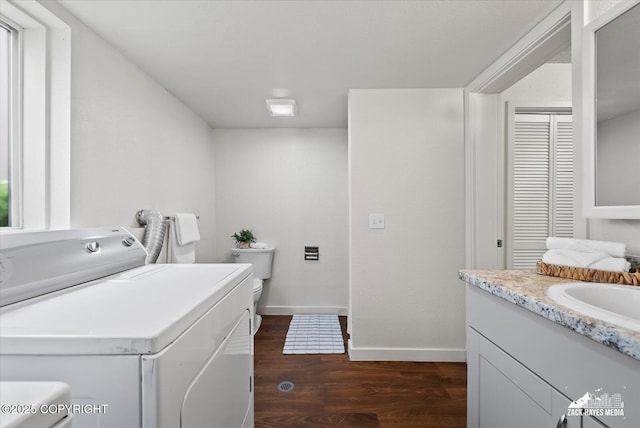 943 E 12th Ave # 6, Anchorage, AK 99501 - laundry area featuring washer / clothes dryer, dark wood-type flooring, and baseboards