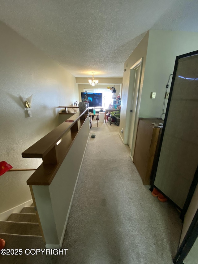 7766 Boundary Ave # G3, Anchorage, AK 99504 - corridor with a textured ceiling, a chandelier, and light carpet