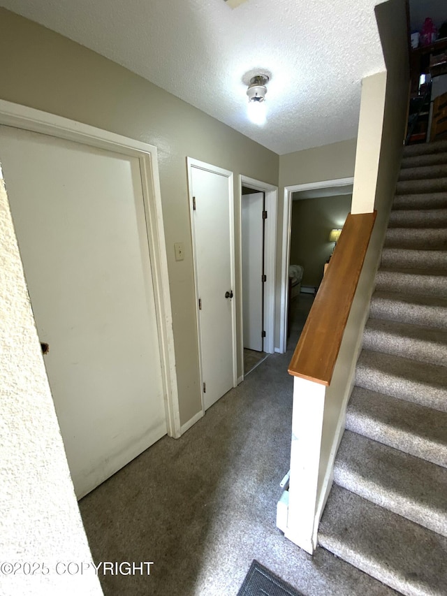 7766 Boundary Ave # G3, Anchorage, AK 99504 - stairs featuring carpet floors and a textured ceiling