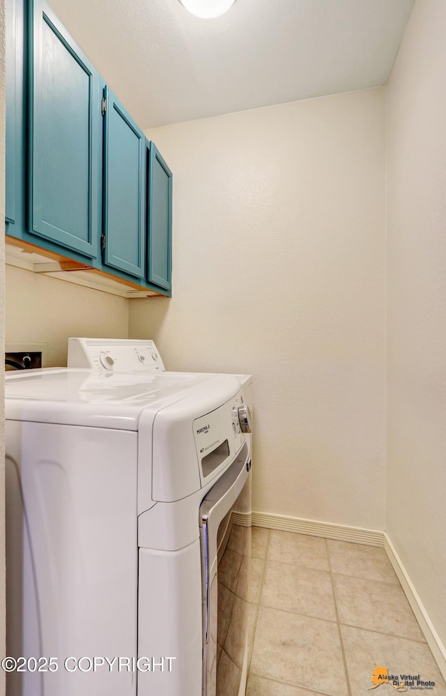 2003 Jamestown Cir, Anchorage, AK 99507 - washroom featuring cabinet space, separate washer and dryer, and light tile patterned floors