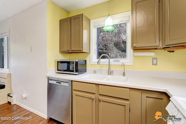 2003 Jamestown Cir, Anchorage, AK 99507 - kitchen featuring stainless steel appliances, wood finished floors, light countertops, baseboard heating, and decorative light fixtures