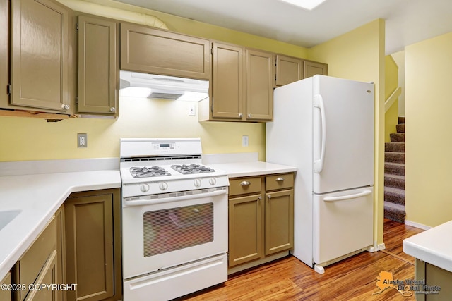 2003 Jamestown Cir, Anchorage, AK 99507 - kitchen featuring white appliances, under cabinet range hood, light wood finished floors, and light countertops