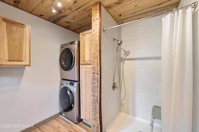 36339 Maria Rd, Homer, AK 99603 - laundry area with stacked washer and clothes dryer, wooden ceiling, and light wood-style flooring