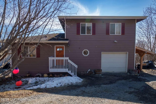 705 W Fairview Ave, Homer, AK 99603 - view of front facade featuring a garage and dirt driveway