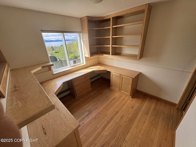 705 W Fairview Ave, Homer, AK 99603 - unfurnished office featuring built in desk, baseboard heating, light wood-style flooring, and baseboards