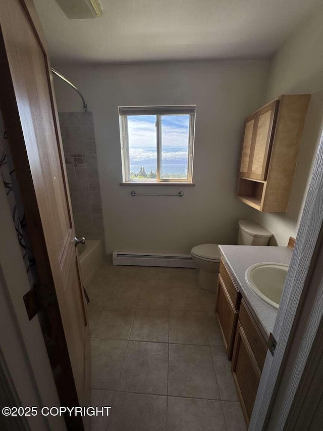 705 W Fairview Ave, Homer, AK 99603 - full bath featuring vanity, toilet, baseboard heating, tile patterned floors, and bathtub / shower combination