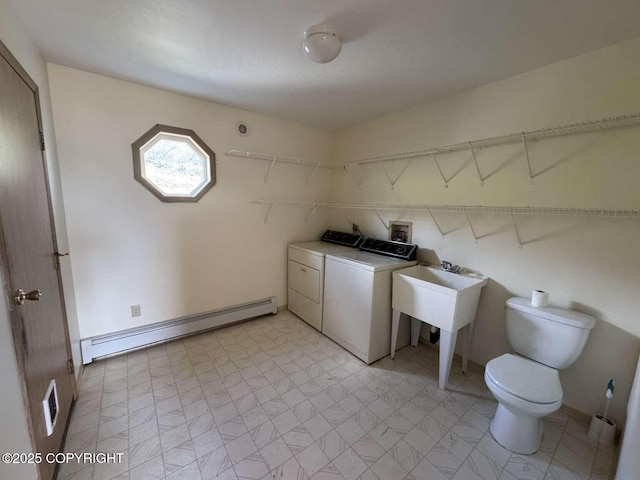 705 W Fairview Ave, Homer, AK 99603 - washroom featuring washer and dryer, a baseboard heating unit, and light flooring