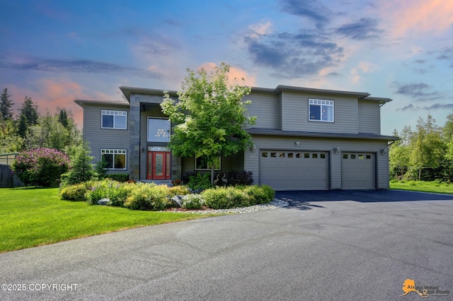 2842 Ensign Dr, Anchorage, AK 99515 - view of front of house featuring an attached garage, asphalt driveway, and a lawn