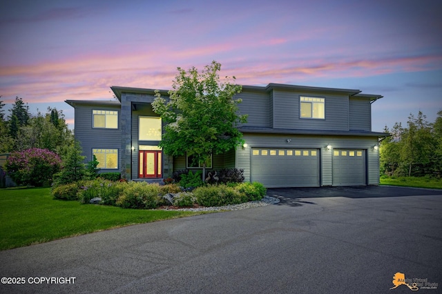 2842 Ensign Dr, Anchorage, AK 99515 - view of front of house with an attached garage, driveway, and a front lawn