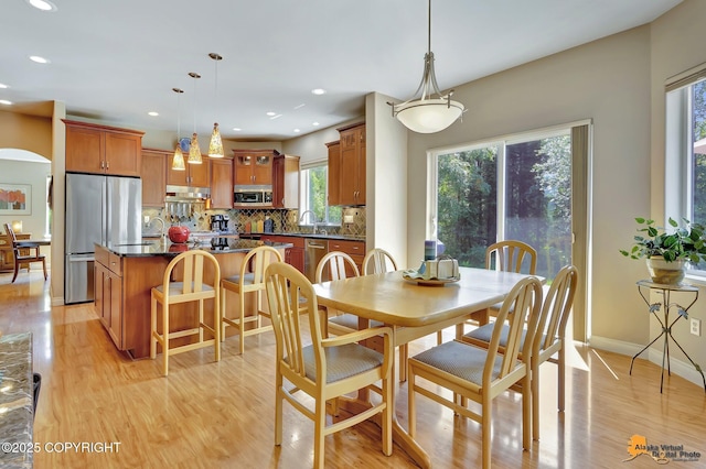 2842 Ensign Dr, Anchorage, AK 99515 - dining room with light wood finished floors, recessed lighting, and arched walkways
