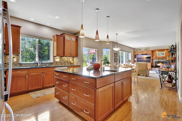 2842 Ensign Dr, Anchorage, AK 99515 - kitchen featuring light wood-type flooring, tasteful backsplash, brown cabinets, and recessed lighting