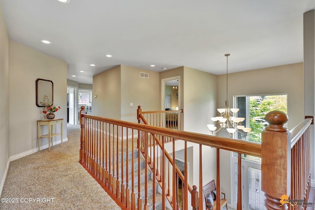 2842 Ensign Dr, Anchorage, AK 99515 - corridor with a chandelier, an upstairs landing, carpet flooring, and recessed lighting