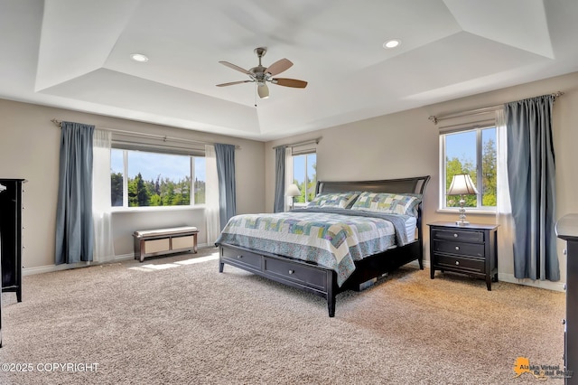 2842 Ensign Dr, Anchorage, AK 99515 - carpeted bedroom with a tray ceiling, multiple windows, ceiling fan, and recessed lighting