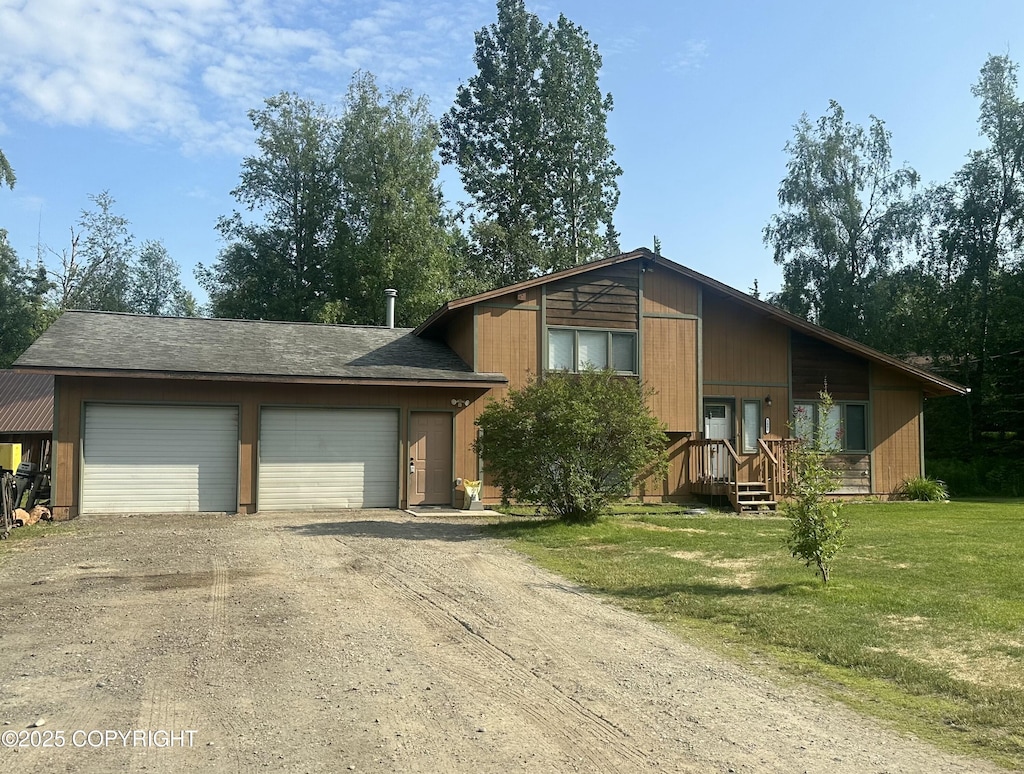 3091 N Longspur Dr, Wasilla, AK 99654 - view of front facade featuring dirt driveway, a front yard, and an attached garage