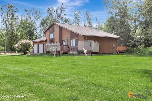 3091 N Longspur Dr, Wasilla, AK 99654 - view of front of property featuring an attached garage, a front yard, a deck, and a shingled roof