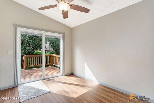 3091 N Longspur Dr, Wasilla, AK 99654 - spare room featuring lofted ceiling, wood finished floors, and ceiling fan